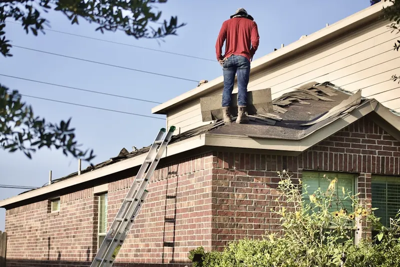 Professional roofer working on a residential roof in Dobson Woods
